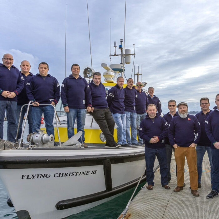 Flying Christine III volunteers presented with 25th anniversary guernseys
